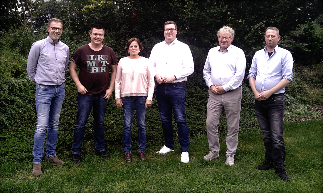 Bild: UWG-Kandidaten mit Vertretern von Gegenstromleitung Ankum e.V. auf einer Rasenfläche im Garten.